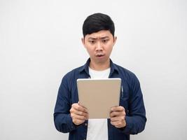 Man looking at tablet in his hand feeling shocked about work photo