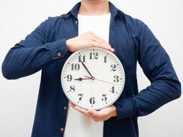 Man holding analog clock in hand work time concept crop shot photo