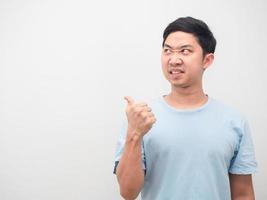 Man angry face looking and point finger at copy space white background photo