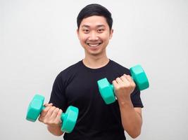 Man holding drumbbell with happy smile motivation workout concept photo