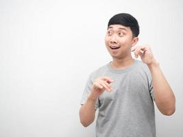 Asian man gesture dancing funny and looking at copy space photo