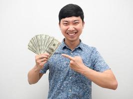 Man happiness gesture point finger at a lot of money in hand isolated photo