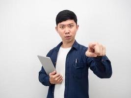 Man with tablet serious face point finger at you photo