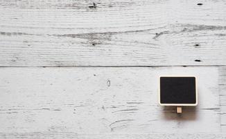 Small chalkboard clip array line on white wood table top view nature shadow space,Idea notice chalkboard concept photo