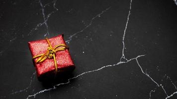 Close up gift box on black marble top view copy space photo