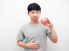 Man gesture hungry want to eatting rip apple in hand photo