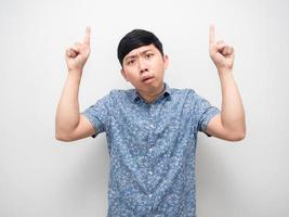 Asian man feel doubt double point finger up above photo