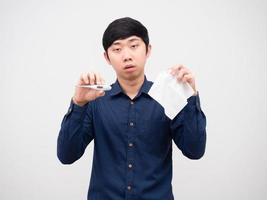 Asian man sick show thermometer and tissue paper in hand unwell face white background photo