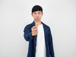 Handsome man show golden bitcoin in his finger with confident face on white background the digital money concept photo