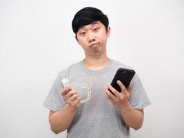 Portrait man holding mobile phone and charging mobile photo