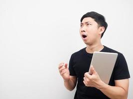 Man holding tablet feeling shocked copy space photo
