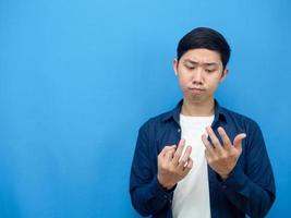 Man counting his finger about something blue background copy space photo