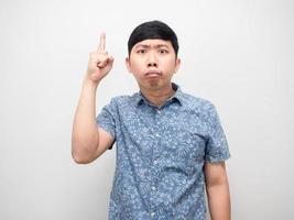 Asian man feel doubt point finger up above photo