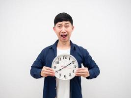 Asian man shocked face hodling clock at ten past eight AM.  in his hand late concept on white background photo