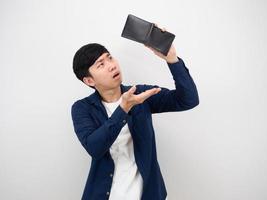 Asian man finding money in his wallet serious face on white background poor man concept photo