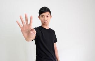 Young Asian man black shirt count one to ten by hand half body on white isolated background,Man counting number concept photo