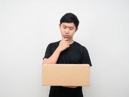 Man looking at shopping box in his hand thinking about something photo