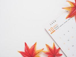 top view maple leaf on the calendar copy space white autumn concept photo