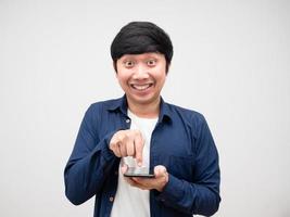 Asian man feeling excited press on smart phone in his hand photo