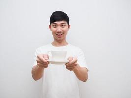 Asian man white shirt happy smile hold coffee cup in hand look at camera invite concept on white background photo