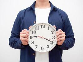 Man holding analog clock in hand crop shot late concept white background photo