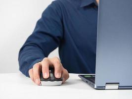 Close up man hand catch mouse of laptop working on the table photo