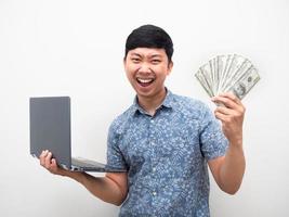 Man get a lot of money with online working feel satisfy and happy showing money photo