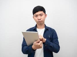 Asian man using tablet for working serious emotion photo