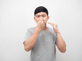 Asian man feeling smelly close his nose portrait white background photo