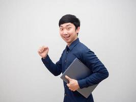 Asian man cheerful holding laptop happy smile going to work concept on white background photo