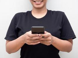 Woman playing mobile phone and checking social media smile face portrait crop body photo