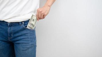 Close up man hand pick up money out of jean pocket white background copy space crop shot photo