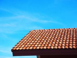 Roof and blue sky landscape,brown roof at right of photo in the sky