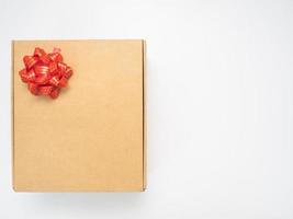 Gift box red ribbon on white table top view copy space photo