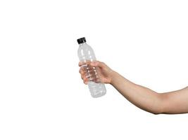 mano que sostiene la botella de agua vacía blanco aislado foto