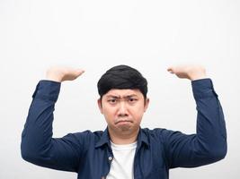 Portrait man gesture carry something serious face,Asian man gesture carry product on his head white background photo