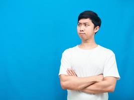 Man white shirt cross arm serious face looking at copy space blue background photo