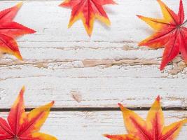 Maple leaf colorful on old wooden copy space top view autumn concept photo