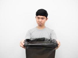 Man holding garbage with serious face angry emotion photo