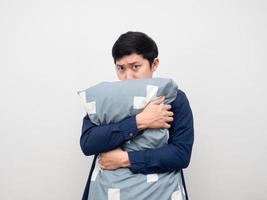 Man hug pillow and looking at camera white background photo