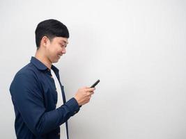 Man playing mobile phone happy smile side view copy space photo