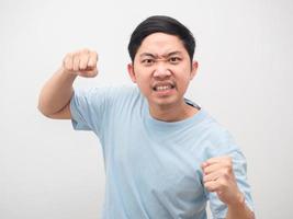 Asian man angry emotion gesture punching white isolated photo