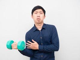 Man feeling tried about work out with holding dumbbell photo