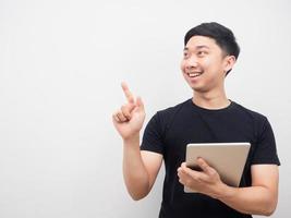 Man holding ipad smile and point finger at copy space photo