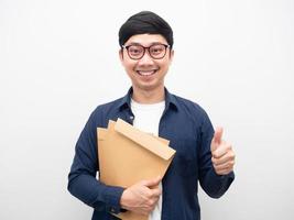 Man wearing glasses holding document envelope smiling thumb up photo