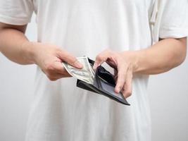 Close up man white shirt pick up money dollar out of his wallet portrait photo