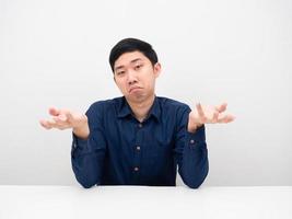 Asian man sitting and feeling doubt gesture up to you photo