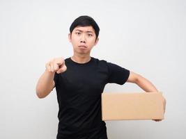 Man holding parcel box and point finger at you photo