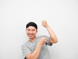 Young man grey shirt gesture pull empty rope on his head photo