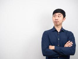 Asian man cross arm looking at copy space white background photo